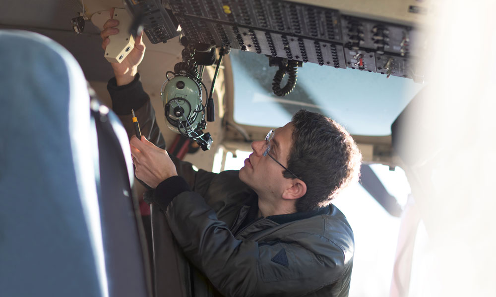 Man looking at interior of helicopter