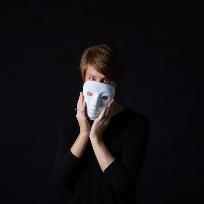 Dr. Leanne ten Brinke peeking beyond a ceramic mask