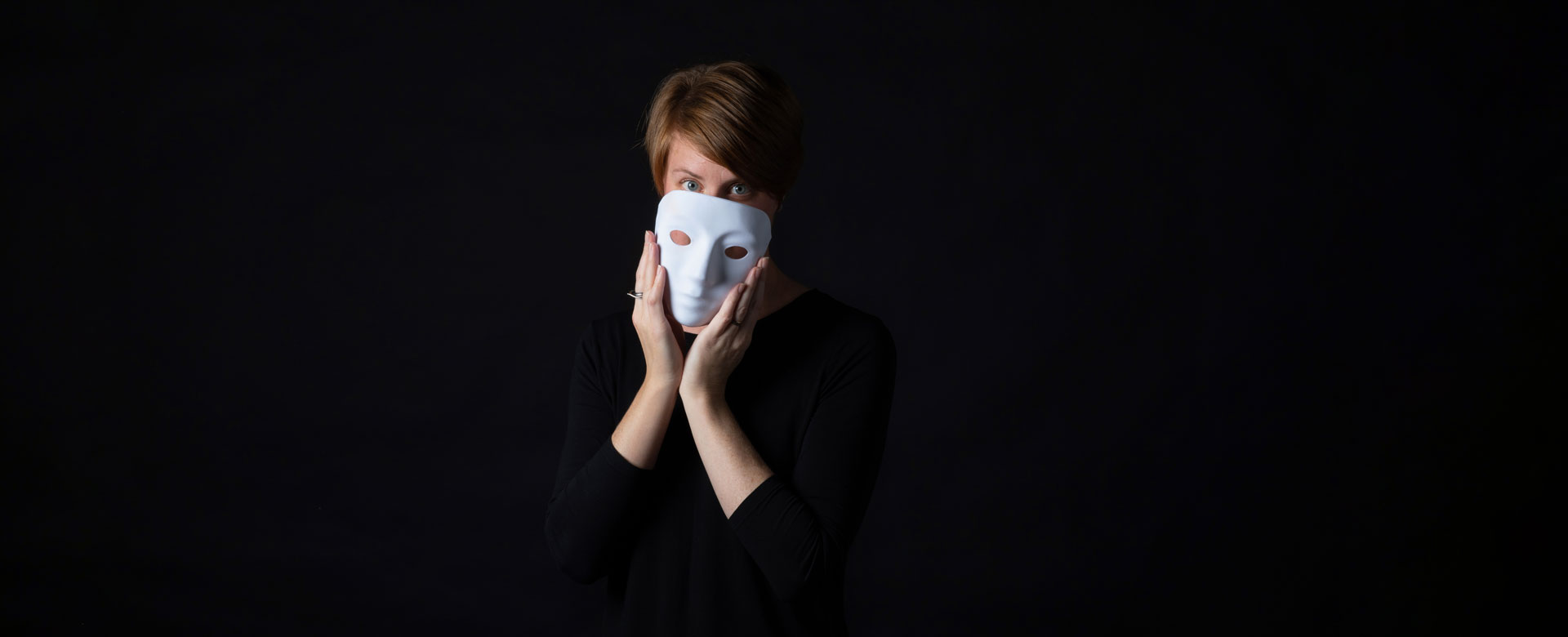 Dr. Leanne ten Brinke peeking beyond a ceramic mask