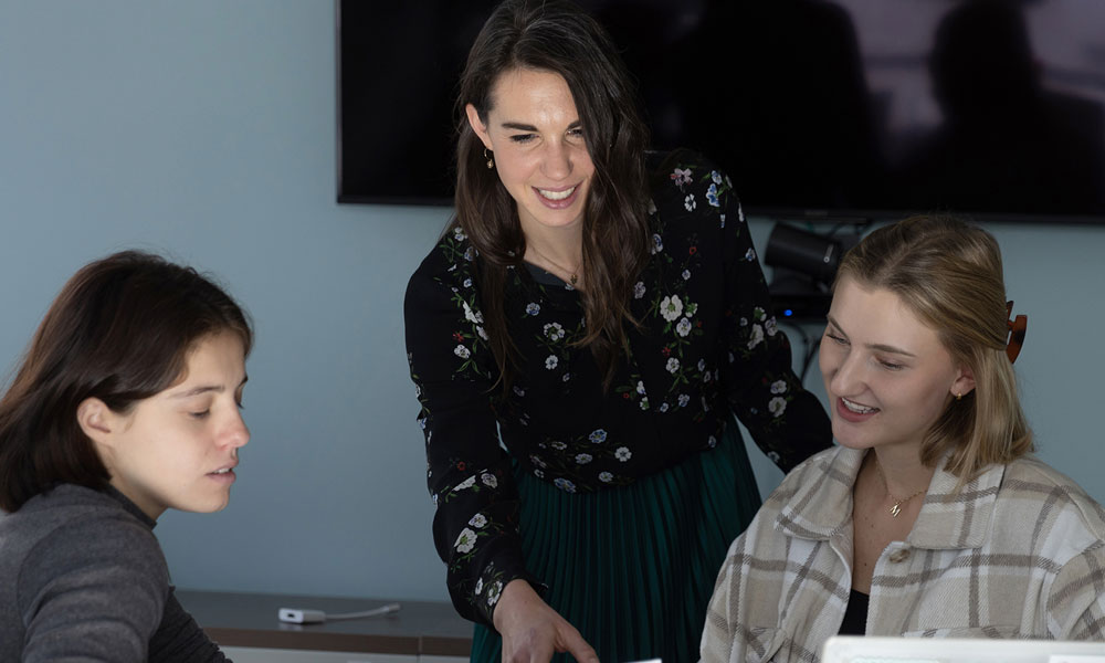 Three women collaborating on some work.