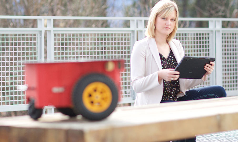 A woman on a tablet device inspecting an engineering project.