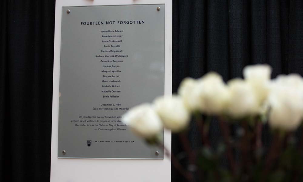 Meorial plaque of 14 Not Forgotten names with roses