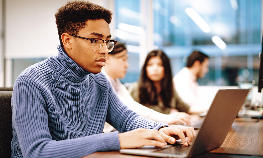 Group of young multi ethnic students working together in coworking space