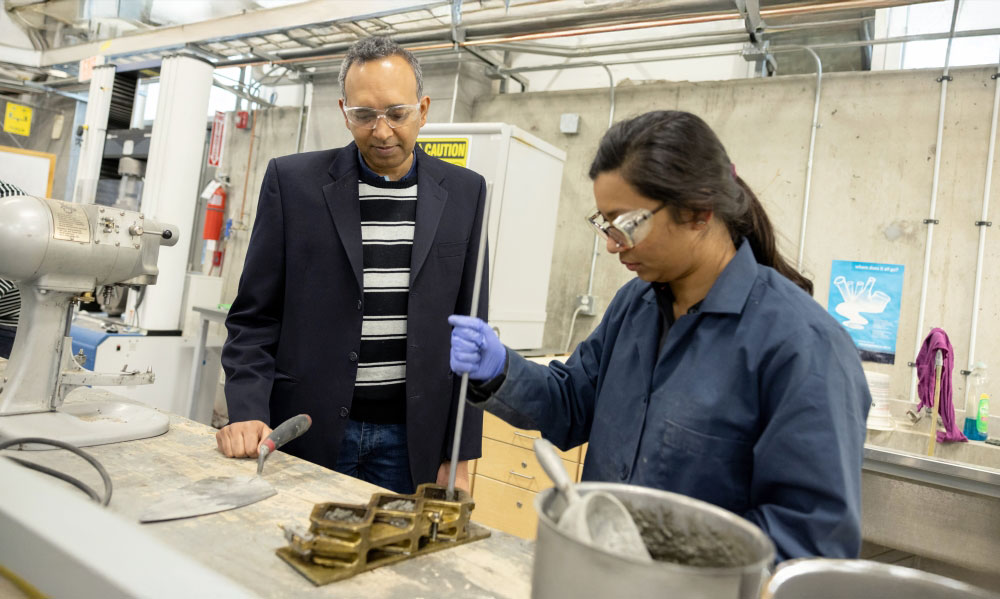 A student and professor working in a lab.